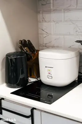 a white toaster sitting on top of a kitchen counter at UP TO 6 PAX! Spacious Loft 2 BR near High Street, BGC Fort Victoria The Fort, Taguig City in Manila