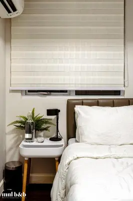 a bedroom with a bed and a side table with a lamp at UP TO 6 PAX! Spacious Loft 2 BR near High Street, BGC Fort Victoria The Fort, Taguig City in Manila