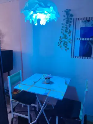 a blue table and chairs with a blue light at Jace Haven 1 Room 2 Beds in Binangonan