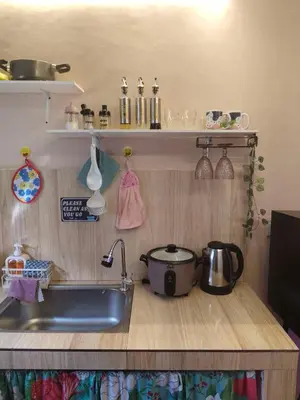 a kitchen counter with a sink and a pot and pans at Jace Haven 1 Room 2 Beds in Binangonan