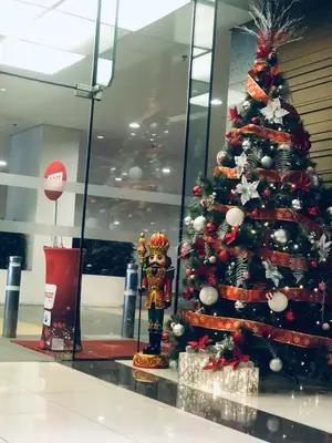 a christmas tree in a mall with a christmas decoration at Hub Metro in makati 100west 1br with balcony in Manila
