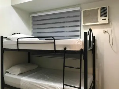 a bunk bed in a room with a window at SMDC Jazz Residence by rhoda kotani in Manila