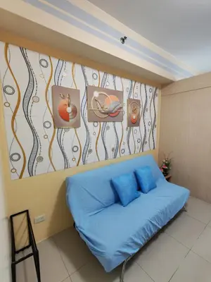 a bed in a room with paintings on the wall at Sea Residences near moa Glenda in Manila