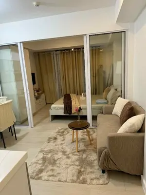 a living room with a couch and a bed at Azure Urban Resort Residences in Manila