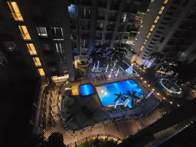 an overhead view of a pool in a city at night at Newport Staycation in Manila