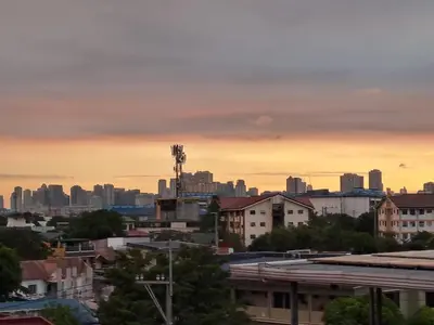 a view of a city skyline at sunset at CORKA Manila in Manila