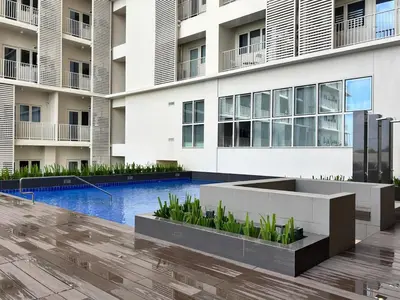 an external view of a building with a swimming pool at 10L Luxe City Escape at Park Mckinley West in Manila