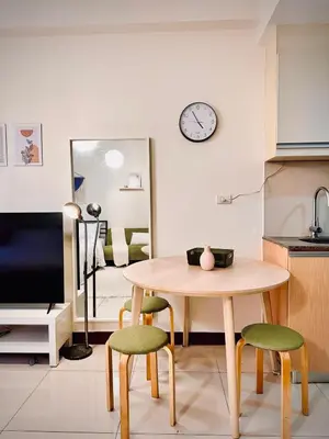 a kitchen with a table and chairs and a clock on the wall at 101 Newport Boulevard near NAIA Terminal 3 in Manila