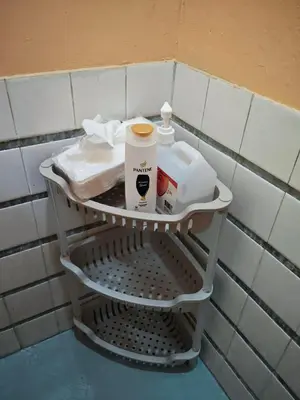 a shelf in a bathroom with toiletries on it at Bunkaroo in Manila