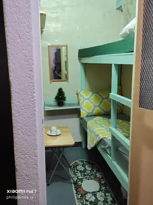 a doll house with a bunk bed and a table at Bunkaroo in Manila