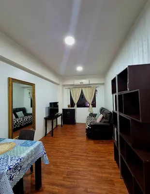 a living room with a couch and a mirror at 1BR Retro-styled Condo unit in BGC, Taguig City in Manila