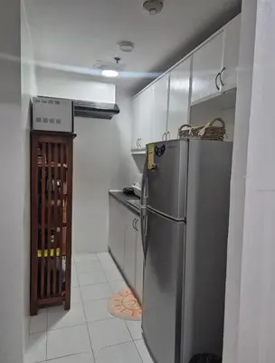 a kitchen with a stainless steel refrigerator and a counter at 1BR Retro-styled Condo unit in BGC, Taguig City in Manila
