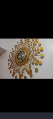 a gold plate with a clock on a table at JC Palace Residence in Manila