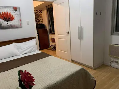 a bedroom with a bed with a flower on it at Azure Urban Resort Residence A51 in Manila