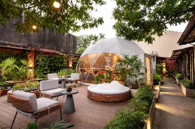 an outdoor patio with chairs and a glass dome at Container Home Mandaluyong N02 in Manila