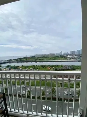 a balcony with a view of a highway and a river at Vacation at HM Place in Manila