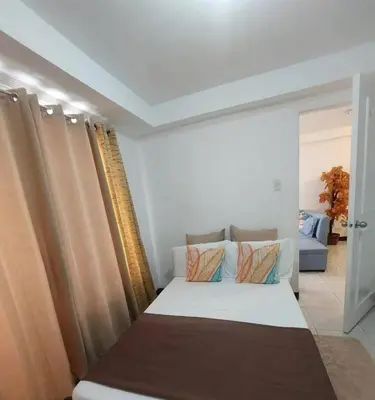 a bedroom with a bed in a room at Condotels by Mandolin Suite in Manila