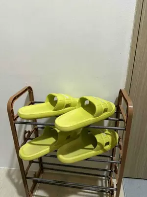a rack with yellow flip flops on it at shore residences admin in Manila