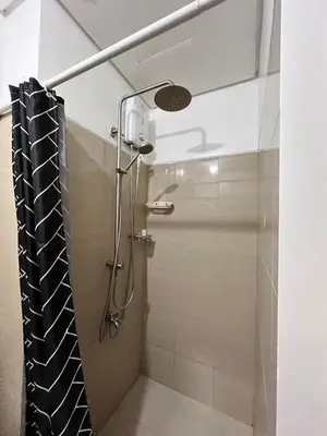 a shower in a bathroom with a shower curtain at Apartment in Pasay at Shore Residences in Manila