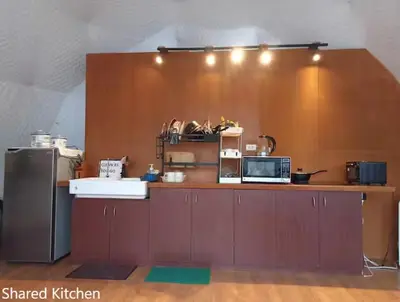 a kitchen with a counter top with a microwave at Container Home Mandaluyong N04 in Manila