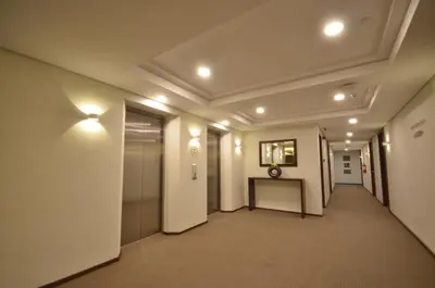 a hallway in a building with lights on the ceilings at Jinjiang Inn - Makati in Manila