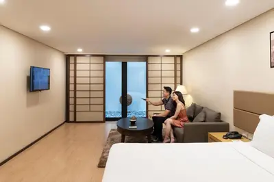 a man and woman sitting in a hotel room at Jinjiang Inn - Makati in Manila