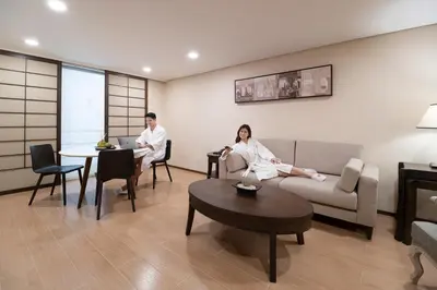 a man and a woman sitting in a living room at Jinjiang Inn - Makati in Manila