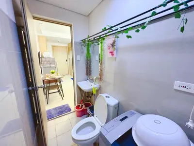a bathroom with a white toilet and a sink at Manila Bay View Shore1 Residence Tower A in Manila