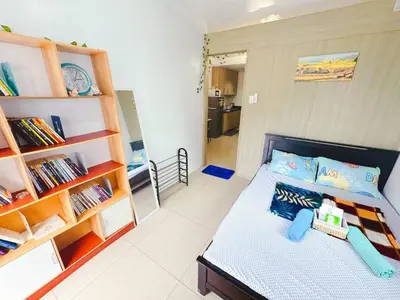 a bedroom with a bed and a book shelf at Manila Bay View Shore1 Residence Tower A in Manila