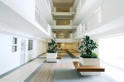 an empty hallway with two potted plants in a building at Mellow Dreams in Manila