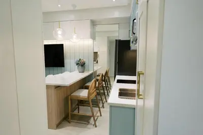 a kitchen with white cabinets and a counter top at Mellow Dreams in Manila