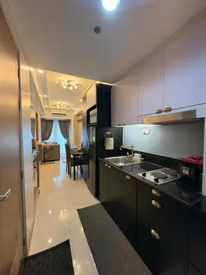 a kitchen with a sink and a table in it at A&P Residence in Manila