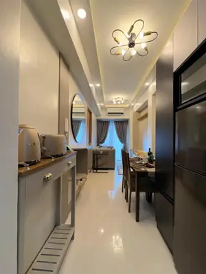 a kitchen and dining room with a ceiling fan at A&P Residence in Manila