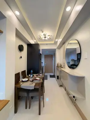 a dining room with a table and a mirror at A&P Residence in Manila