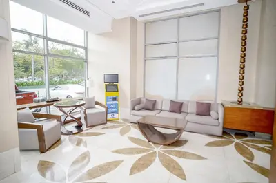 a living room with a couch and a table at Eton Baypark Manila Bay in Manila
