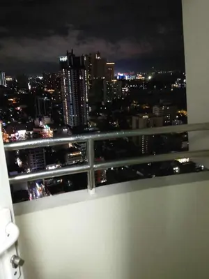 a view of a city at night from a bathroom window at Birch tower condo for renting in Manila