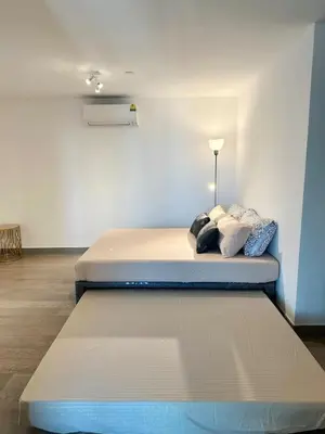 two mattresses in a room with a bed at New Modern Luxurious 1 Bedroom Condo with WIFI and Netflix in Manila