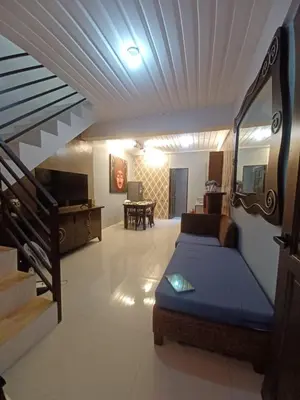 a bedroom with a bed and a living room at 88 Residences in Manila