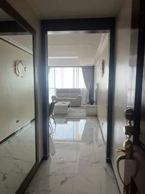 a hallway leading to a living room with a couch at Robinson's place residences tower 2 in Manila