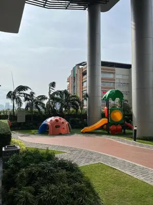 a playground with a slide and a play structure at Luxe Hotel-Style Suite Stay at Ayala Ave in Manila