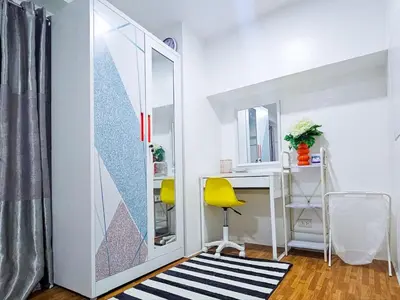 a room with a mirror and a desk and a yellow chair at CitiClcentro Condo Near everything in Manila