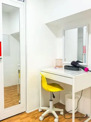 a white desk with a yellow chair and a mirror at CitiClcentro Condo Near everything in Manila