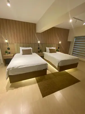 a bedroom with two beds and a rug at Edsa Heights Unit 3416 Cozy 1 br Loft Penthhouse Unit with 2 full beds Ama Tower in Manila