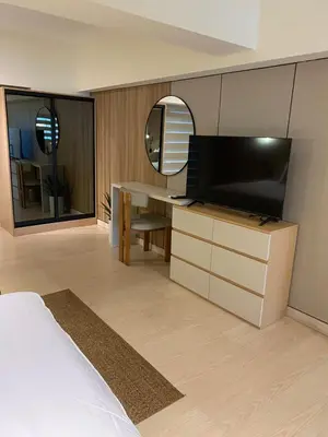 a hotel room with a bed and a television at Edsa Heights Unit 3416 Cozy 1 br Loft Penthhouse Unit with 2 full beds Ama Tower in Manila
