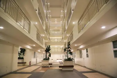 a large hallway with potted plants in a building at CoZ studio near MAKATI CBD MOA NAIA in Manila