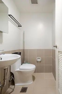a bathroom with a white toilet and a sink at CoZ studio near MAKATI CBD MOA NAIA in Manila