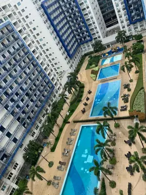 an overhead view of two large buildings with palm trees at Sea Residences DINA in Manila