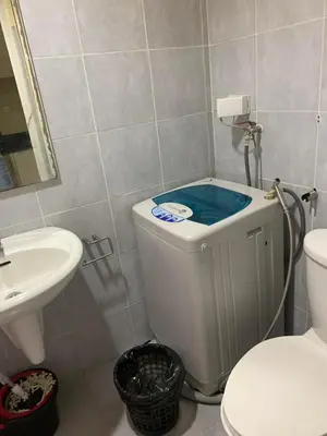 a small bathroom with a toilet and a sink at Sea Residences DINA in Manila