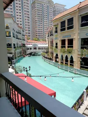 a large swimming pool in the middle of a city at Modern 1 bedroom spacious apartment with Venice Grand Canal View in Manila