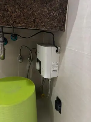 a coffee maker on the corner of a wall at Newport Inn in Manila